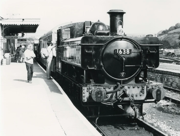 a black and white photo of a train pulling into a station, a black and white photo, private press, waiting, 1981 photograph, brown, 1863