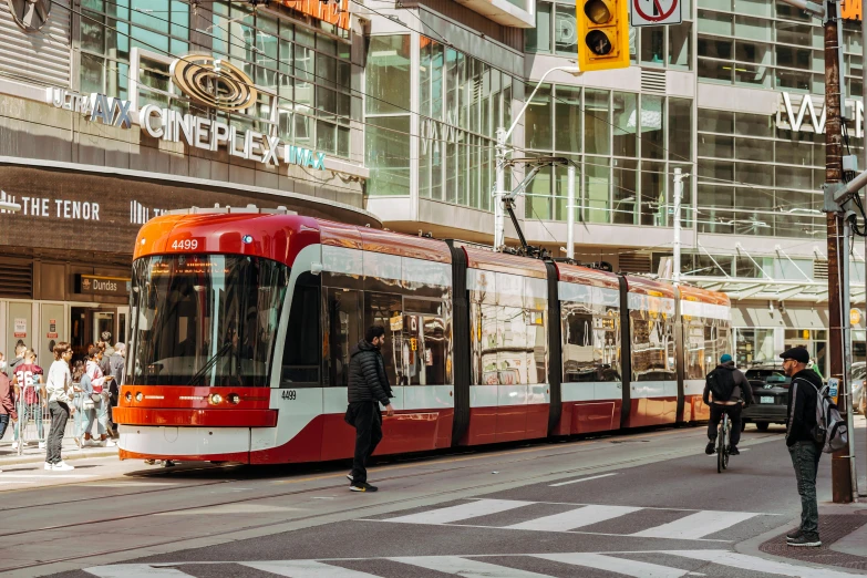 a red and white train on a city street, by Julia Pishtar, pexels contest winner, renaissance, cn tower, orange line, 🚿🗝📝