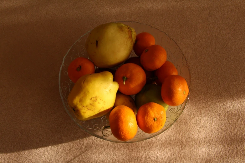 a bowl of fruit sitting on top of a table, by Nathalie Rattner, pexels, photorealism, orange light, various posed, unedited, slide show