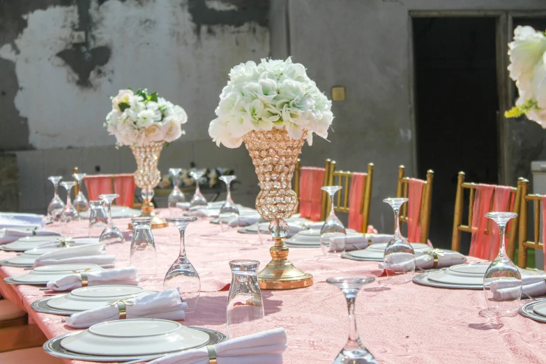 a wedding table with tall floral arrangements