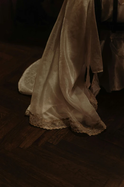 a beautiful dress and a veil sitting on top of a floor