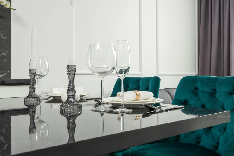 an elegant dining table set for eight with glasses