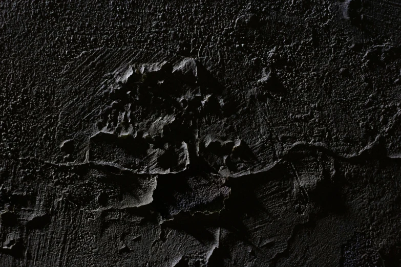 a black wall with peeling paint on it, inspired by Jan Lievens, featured on zbrush central, on the surface of an asteroid, lively irregular edges, top down extraterrestial view, embossed paint