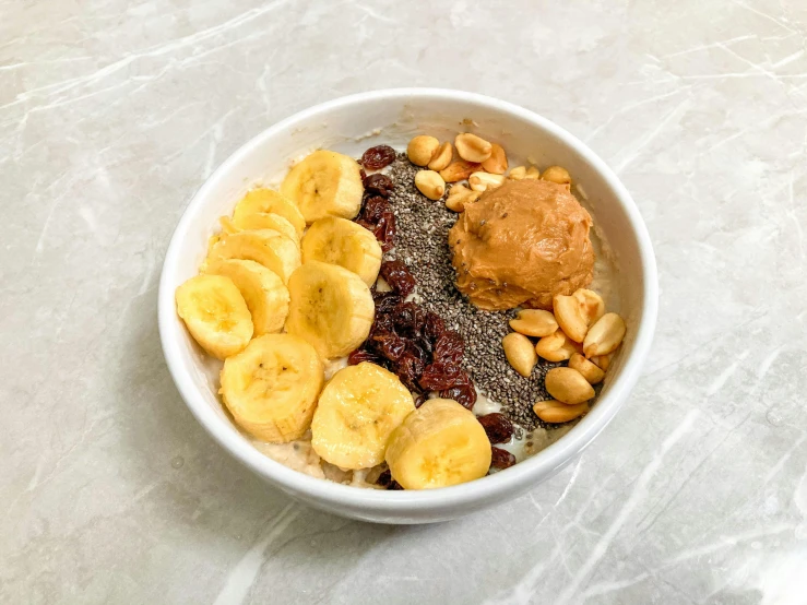 bowl of cereal with peanuts, fruit and peanut er