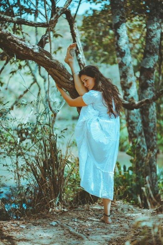 a woman in a white dress standing next to a tree, inspired by Elsa Bleda, pexels contest winner, brunette fairy woman stretching, cottagecore hippie, isabela moner, sea - green and white clothes