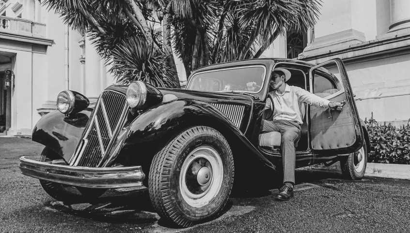 a black and white photo of a man standing next to a car, a black and white photo, pexels contest winner, renaissance, old hollywood themed, 15081959 21121991 01012000 4k, resting, florida man