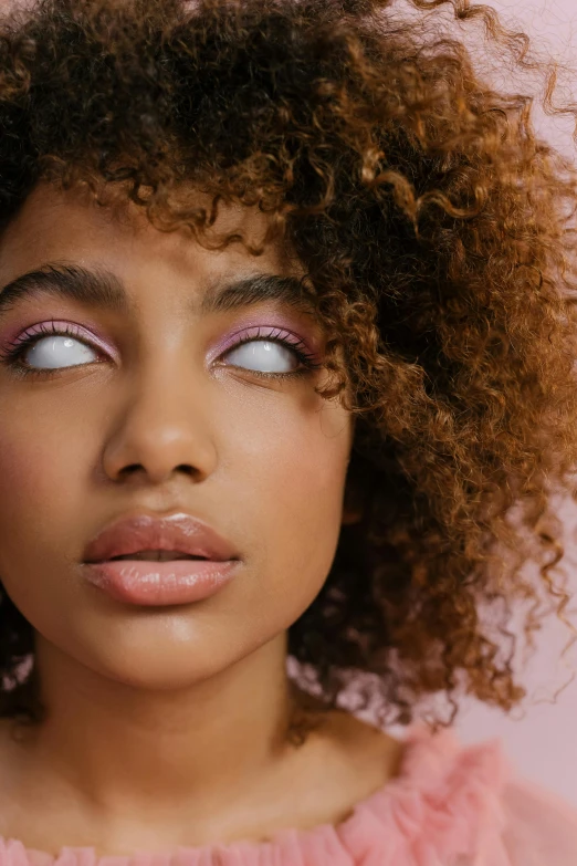 a close up of a young woman with eye makeup