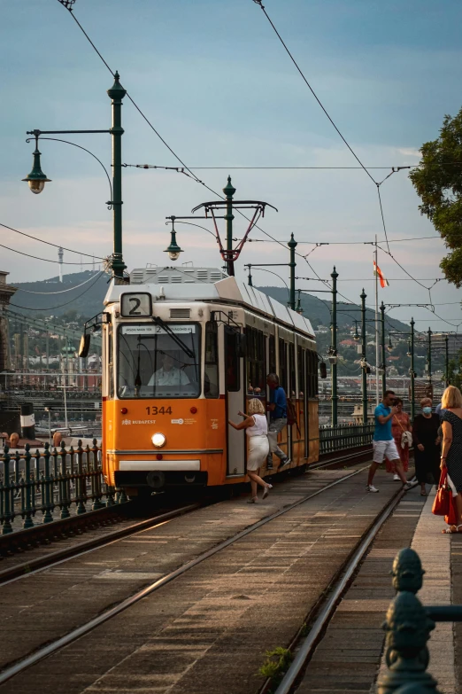 people are getting on a cable car in the city