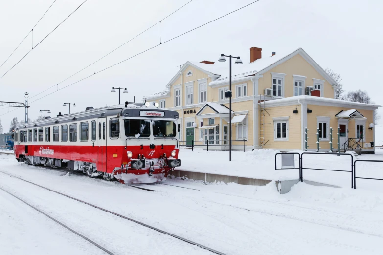 a red and white train traveling down train tracks, by Veikko Törmänen, square, cold snowy, preserved historical, grey