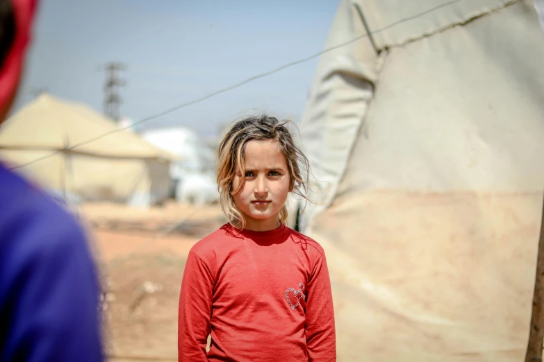 a little girl standing in front of a tent, by Ibrahim Kodra, pexels contest winner, hurufiyya, human face with bright red yes, girl with brown hair, real life photo of a syrian man, 15081959 21121991 01012000 4k