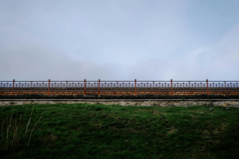 a train passing through an empty field and rail road tracks