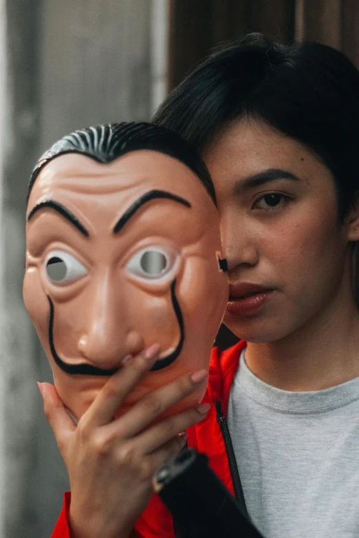 a man holding onto the head of a cartoon character
