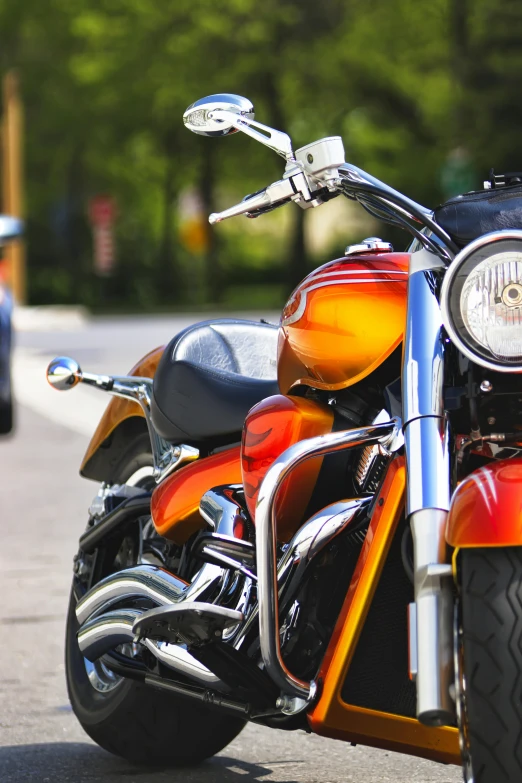 a motorcycle parked on the side of the road, upclose, square, orange, brown