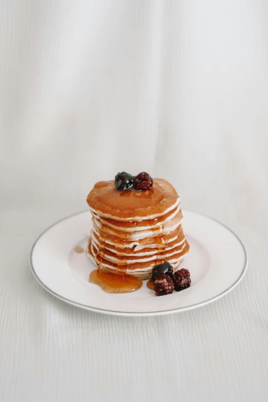 a stack of pancakes sitting on top of a white plate, unsplash, medium format. soft light, gif, “berries, caramel