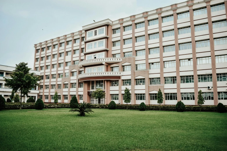 a building sits outside in front of some bushes