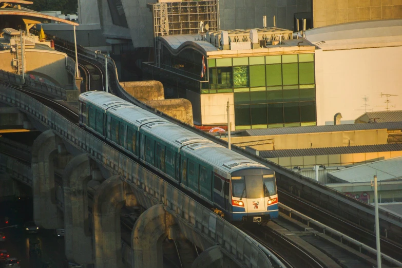 a large long train on a steel track, by Carey Morris, pexels contest winner, renaissance, singapore city, avatar image, mrt, 1980s photo