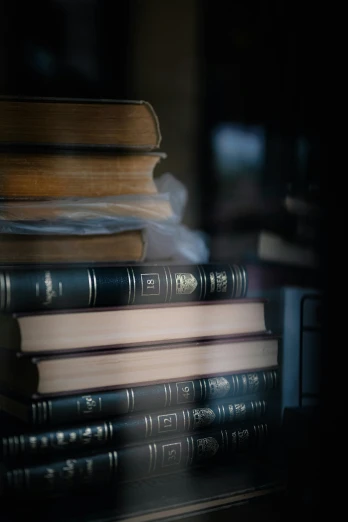 a stack of books sitting on top of a table, a picture, paul barson, up close image, biblical image, 8k 50mm iso 10