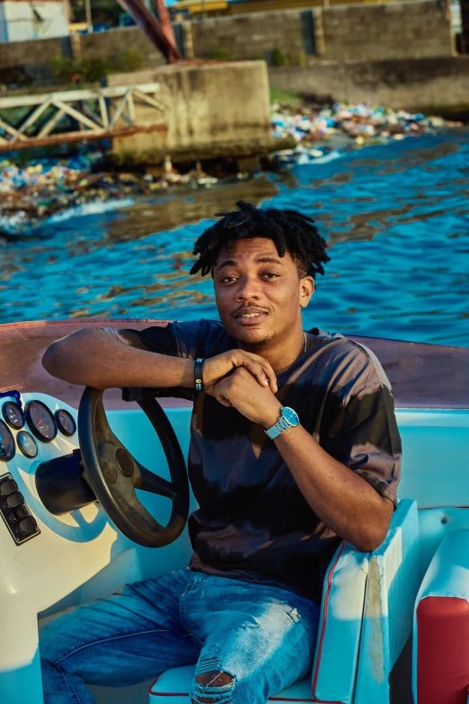 a man in black shirt sitting on the front of a boat