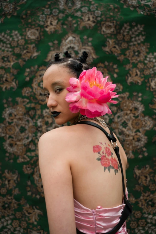 a woman with a pink flower in her hair, an album cover, trending on pexels, renaissance, ashteroth, tattooed, portrait n - 9, portrait sophie mudd