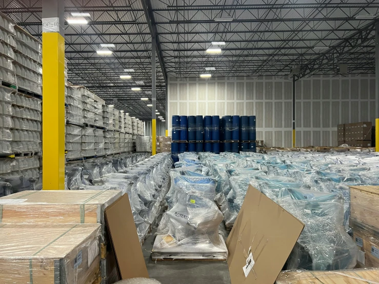 a warehouse filled with lots of boxes and pallets, reddit, process art, many cryogenic pods, high quality photo, fan favorite, blue and yellow lighting