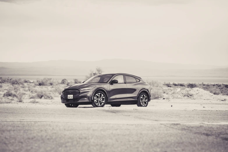 a black and white photo of a car parked on the side of the road, a picture, by Josh Bayer, unsplash, haval f 7, mustang, futuristic in the desert, electric breeze