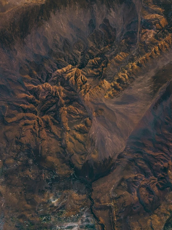 the aerial view shows brown vegetation and brown hills