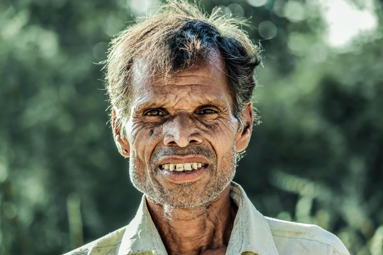 a close up of a person wearing a shirt, a character portrait, pexels contest winner, samikshavad, farmer, timid and vulnerable expression, smiling man, aboriginal capirote