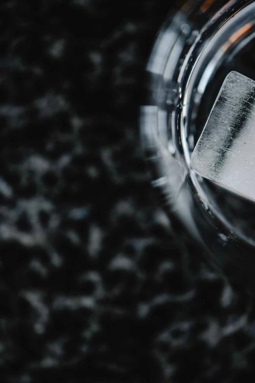 a close up of a silver object with a black background