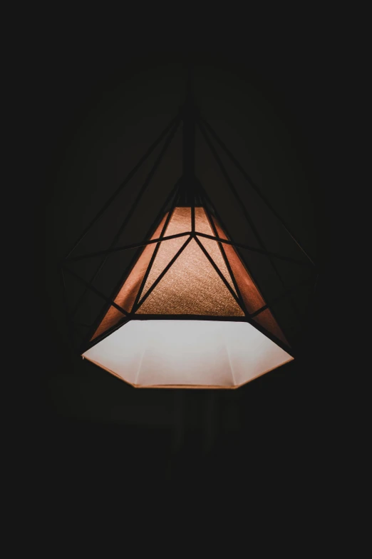 a light hanging from the ceiling in a dark room, instagram post, geometric, lantern, light cone