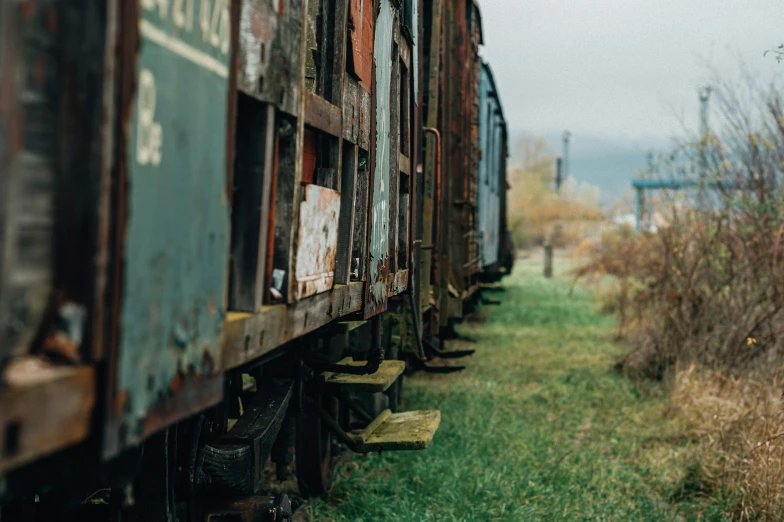 a train that is sitting in the grass, an album cover, unsplash, rusty vehicles, thumbnail, anna nikonova, trading depots