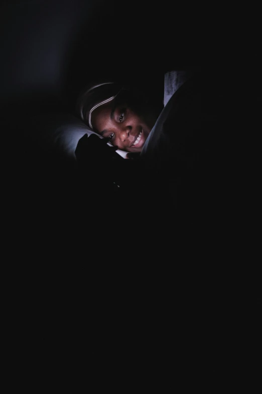 a child looking at a cell phone in the dark, an album cover, inspired by Gordon Parks, pexels contest winner, hurufiyya, jemal shabazz, waking up, light smile, ignant