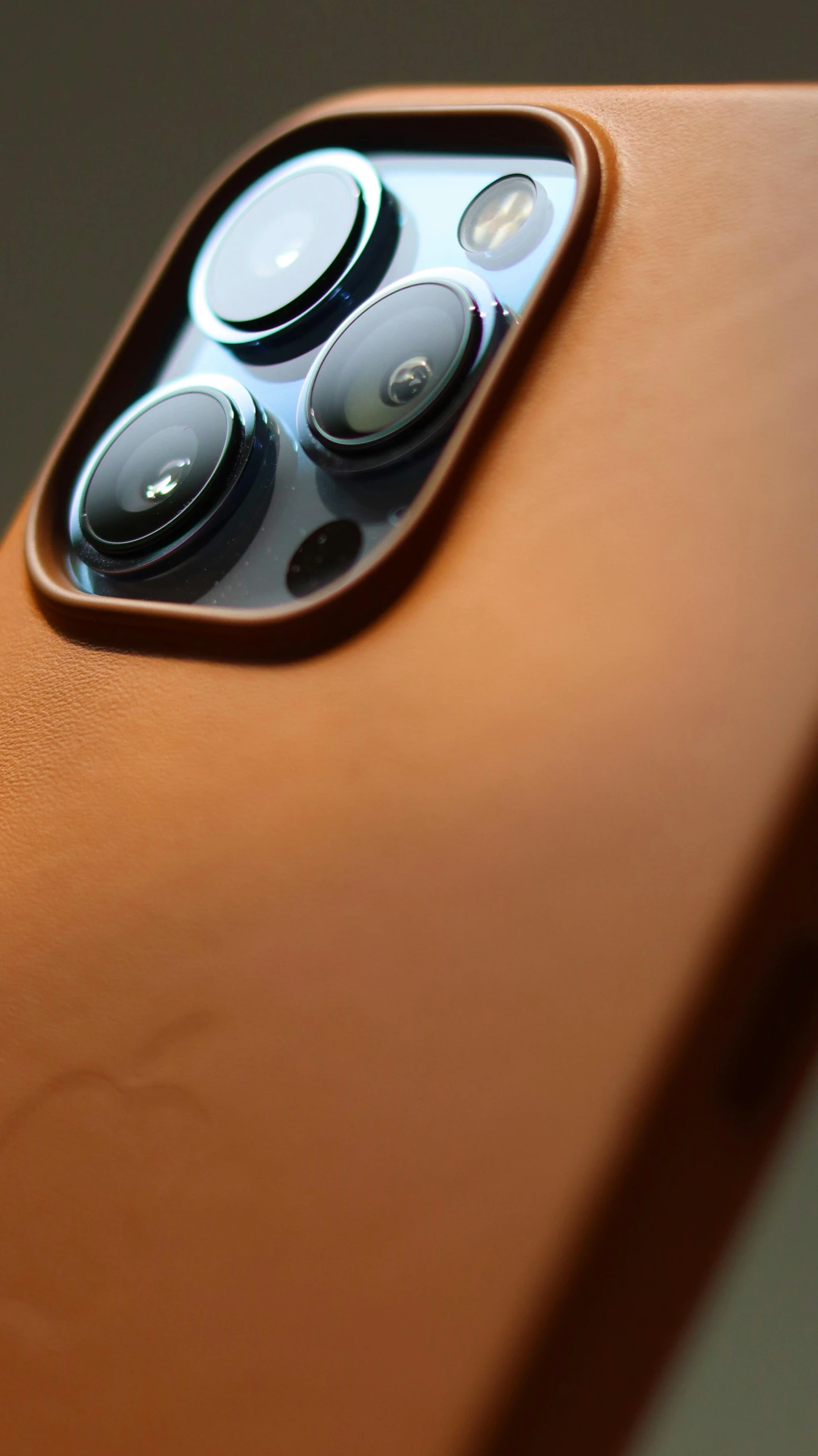 a close up of a cell phone on a table, by Android Jones, trending on pexels, photorealism, brown leather armor, with anamorphic lenses, 3 / 4 view from back, orange