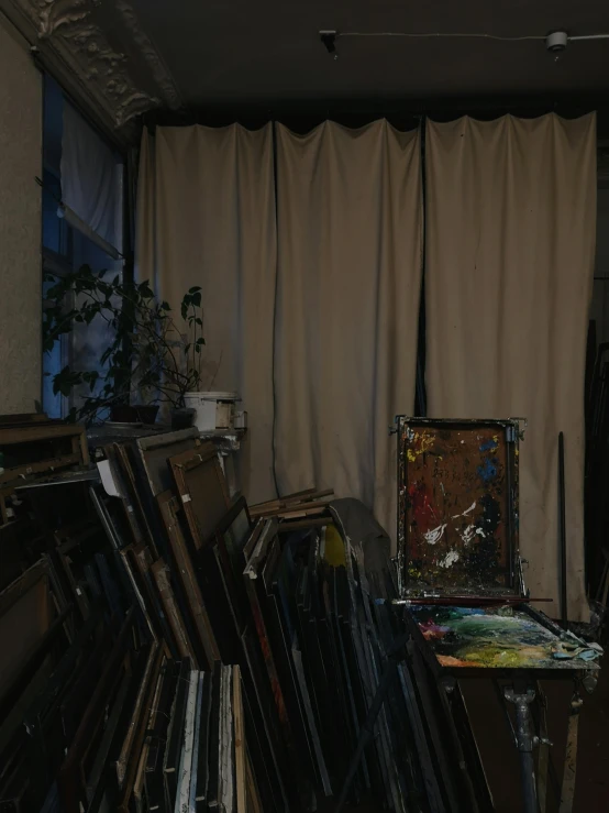 an assortment of vinyl and vinyl records in front of curtains