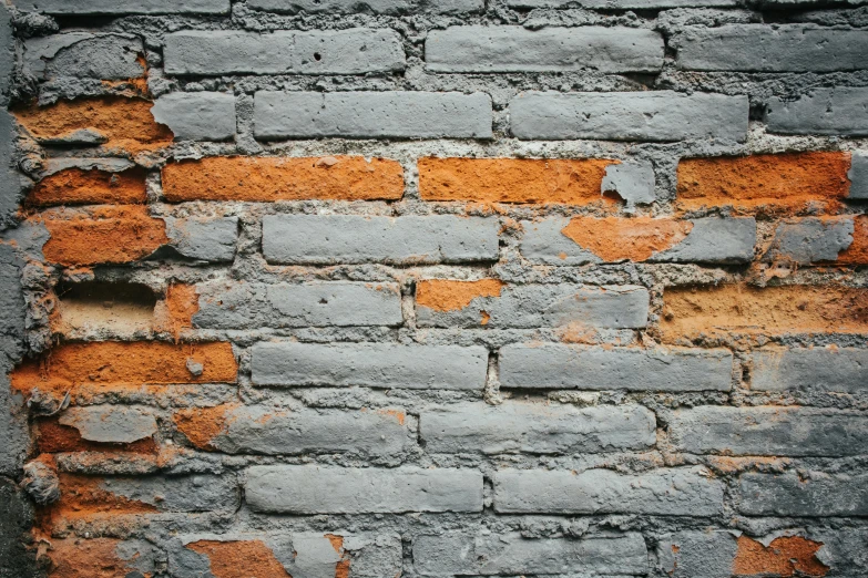 the old brick wall is brown and gray