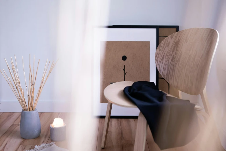 a small table with a vase with plants and candles