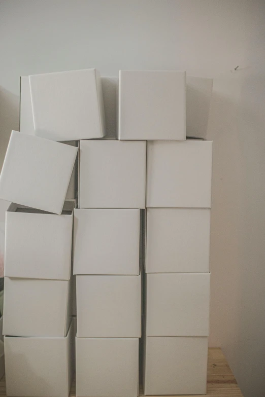 a pile of white boxes sitting on top of a wooden table, 2 5 6 x 2 5 6, multiple stories, curated collections, diy