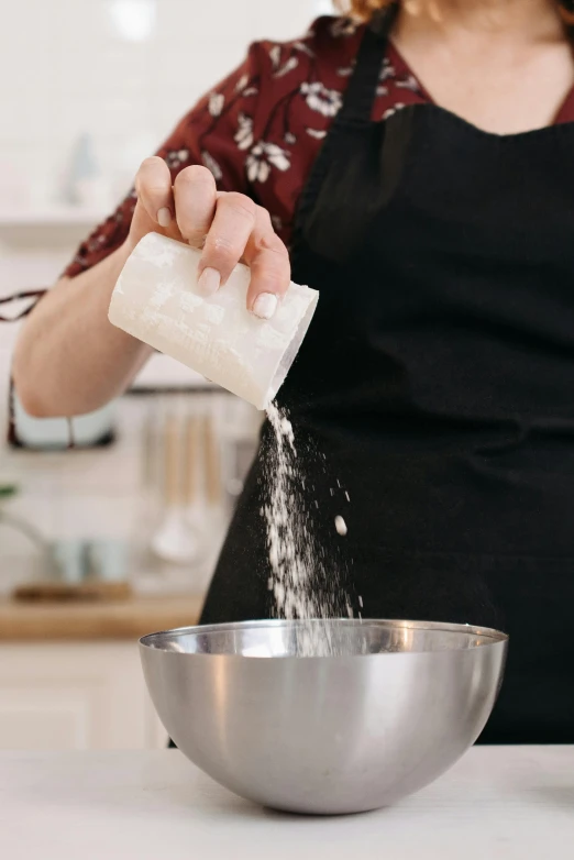 a woman in an apron sprinkles sugar into a bowl, pexels, sydney hanson, made of carrara marble, gif, tall