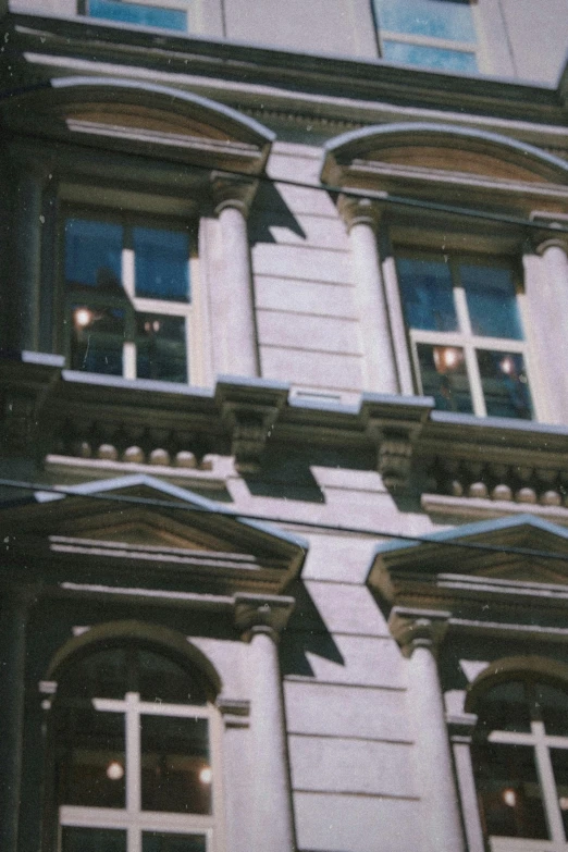 a tall building with a clock on the front of it, by Christopher Wren, photorealism, hoog detail, sunny bay window, royal academy, taken with a disposable camera