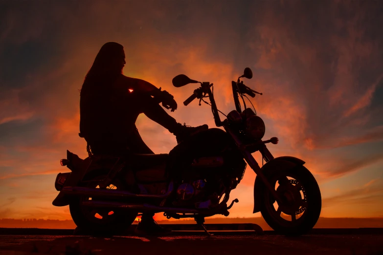 a man riding on the back of a motorcycle at sunset, an airbrush painting, pexels contest winner, art photography, cosplay on black harley queen, silhouette :7, sith lord. dramatic lighting, profile image