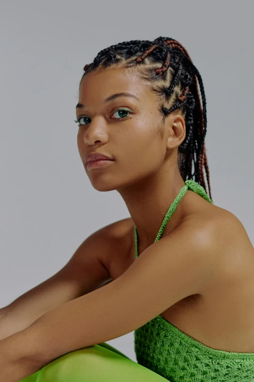 a woman in a green top and green leggings, an album cover, inspired by Sophia Beale, trending on pexels, renaissance, cornrows braids, model face, zendaya, shot with sony alpha 1 camera