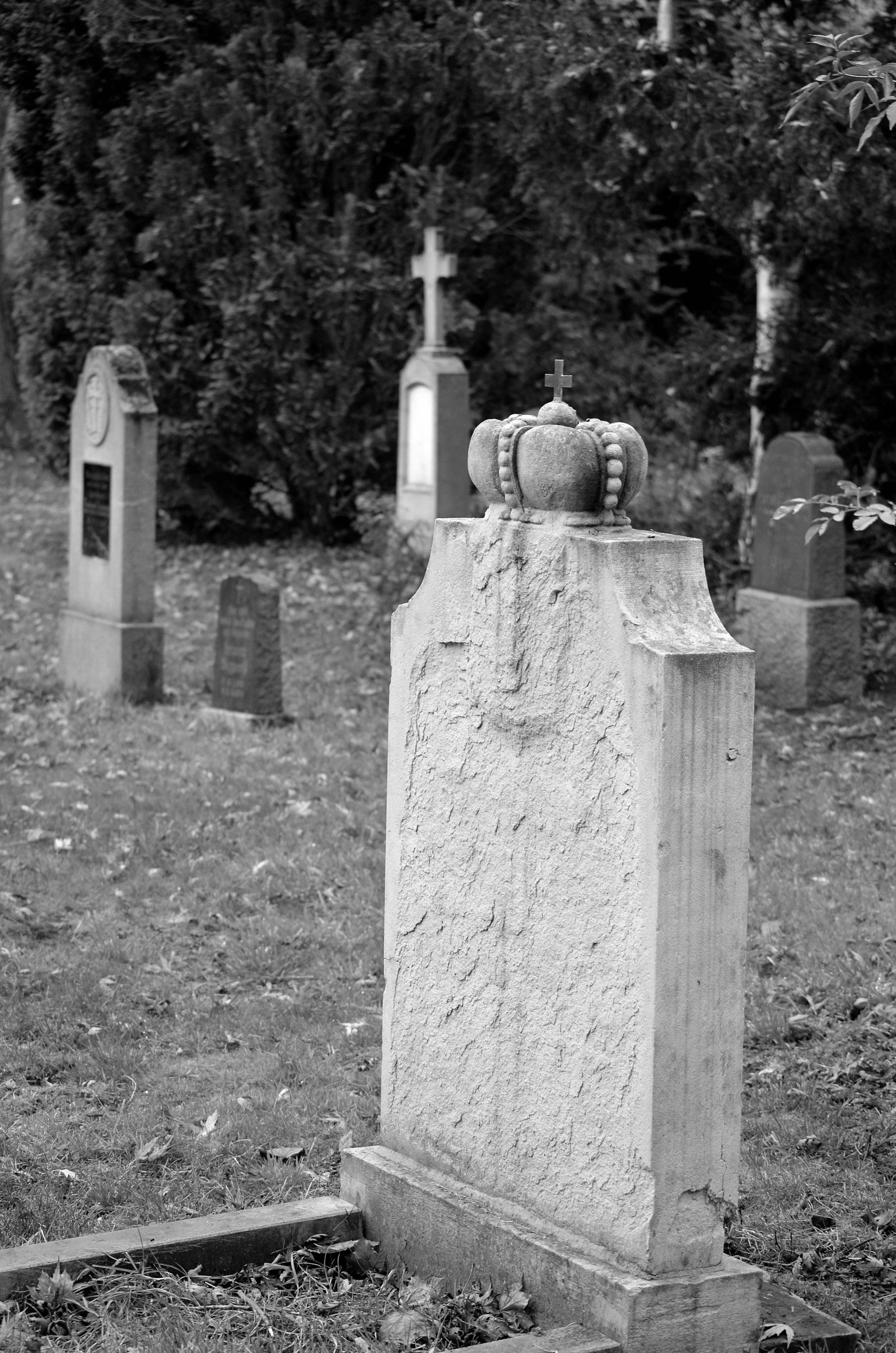 an old tombstone with vases on it sitting in the grass