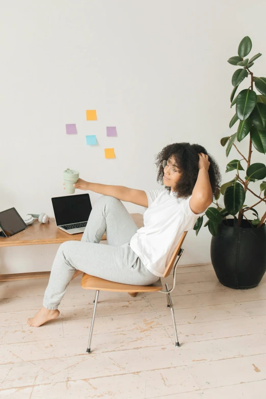 a woman sitting in a chair with a laptop, trending on pexels, happening, paper cutouts of plain colors, sitting on a curly branch, notes, dynamic moving pose