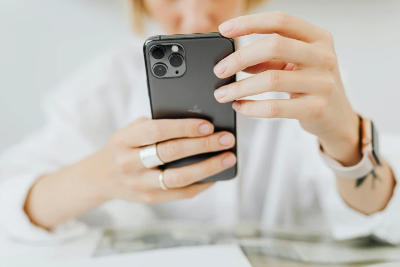 a close up of a person holding a cell phone, trending on pexels, curated collections, feminine looking, reddit post, digital matte