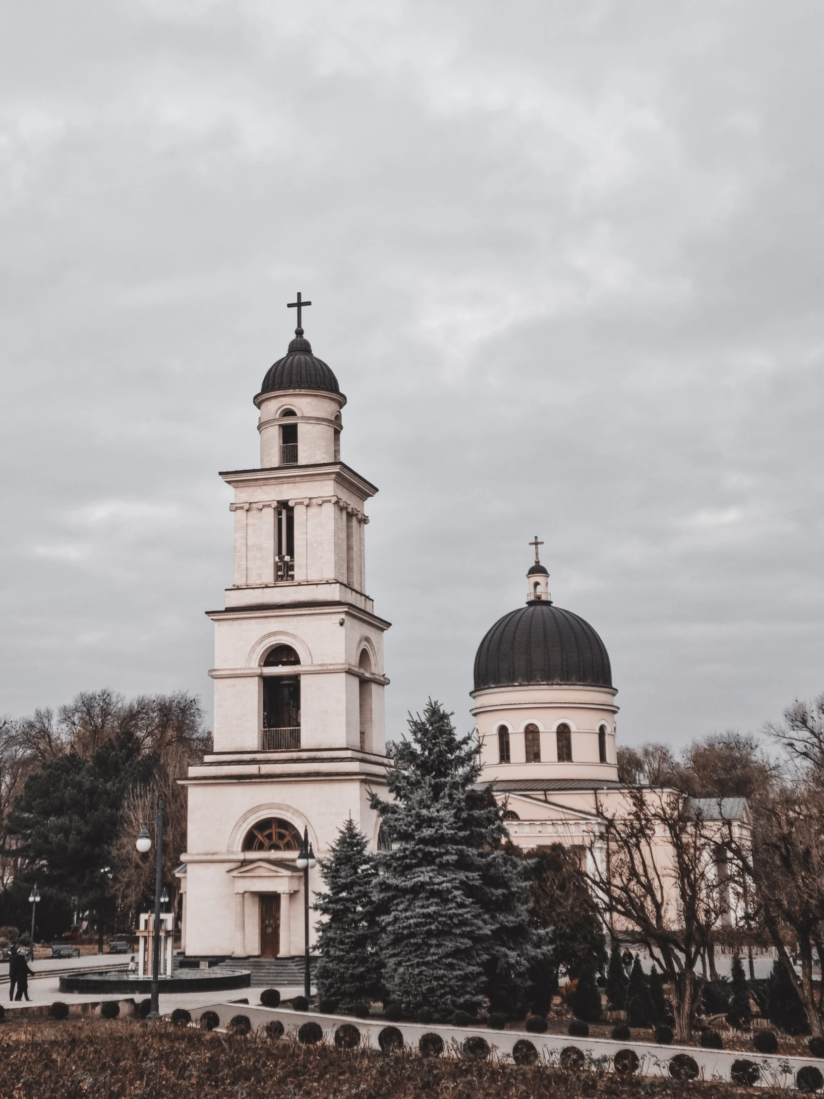 a large white building with a clock tower, a photo, by Emma Andijewska, pexels contest winner, orthodox saint, two towers, 👰 🏇 ❌ 🍃, slight overcast weather