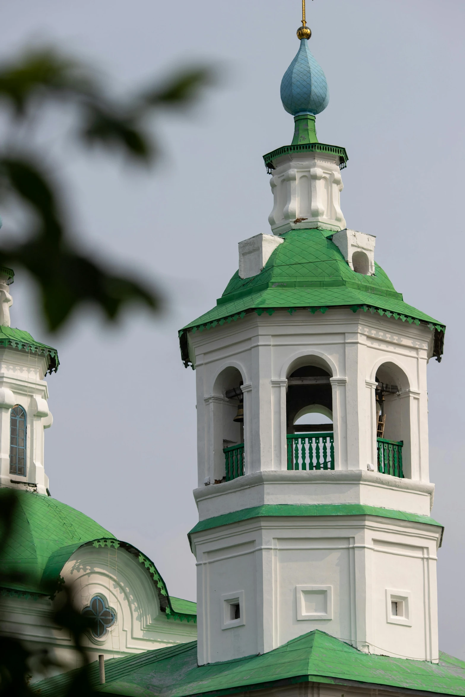 a green and white building with a clock tower, inspired by Illarion Pryanishnikov, domes, up close image, monastery, two towers