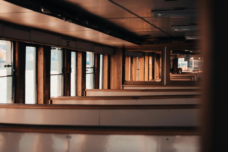 a room filled with lots of windows next to each other, by Carey Morris, unsplash, on a boat, underground, interior wood, blank