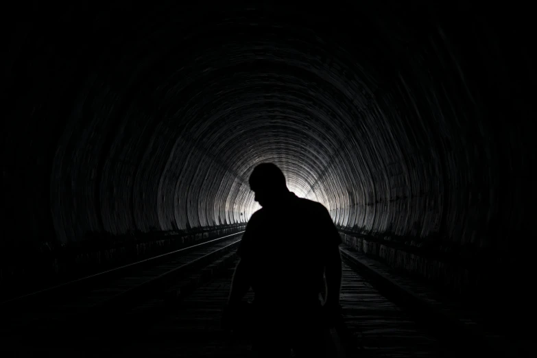 a man standing in the middle of a dark tunnel, profile pic, trauma, mining, instagram picture