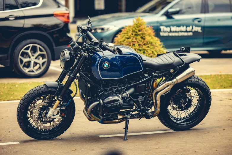 a black and blue motorcycle parked in a parking lot, a stipple, unsplash, scrambler, 🚿🗝📝, profile image, bmw