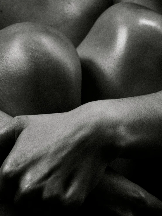 a black and white photo of a naked man, a black and white photo, inspired by Robert Mapplethorpe, pexels contest winner, figurative art, holding each other hands, photo of a black woman, closeup of arms, body builder