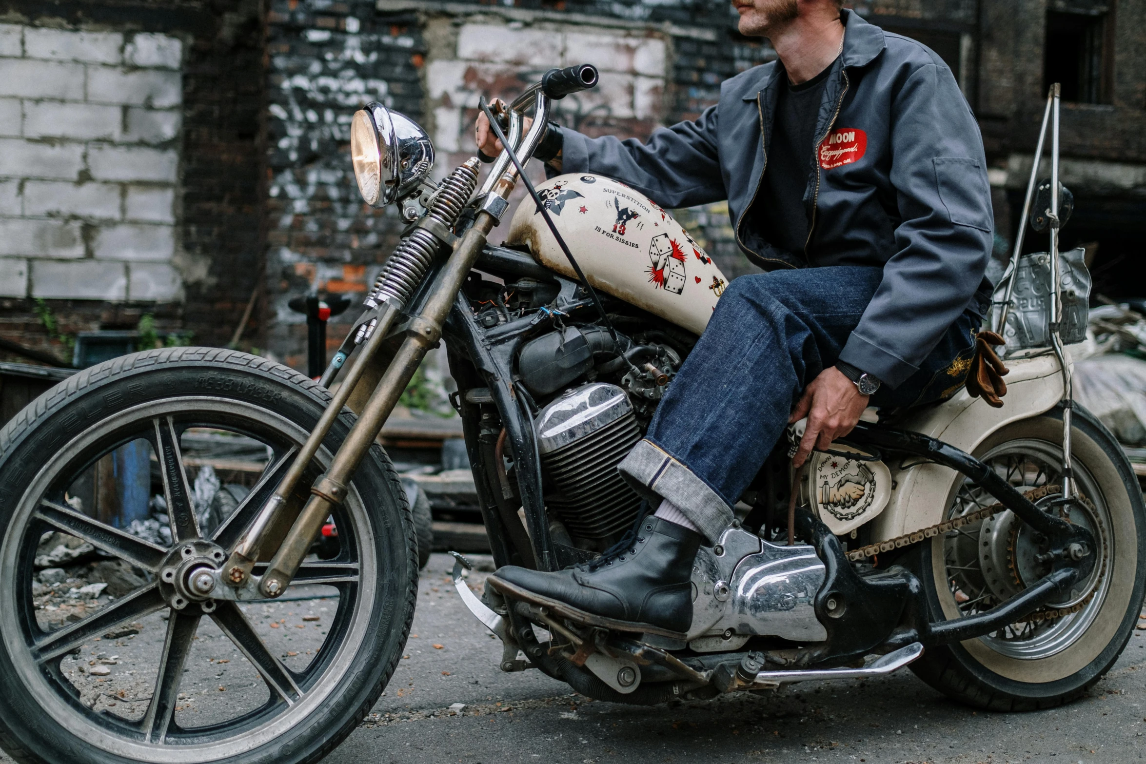 a man that is sitting on a motorcycle, unsplash, lowbrow, wearing boots, 9 9 designs, battle worn, full shot photo